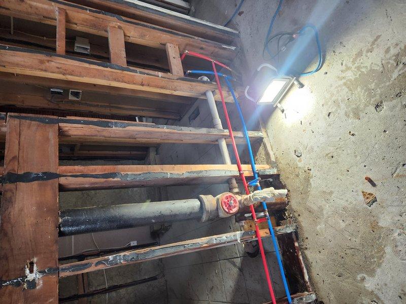 Removed leaking waterlines and meter horn assembly from mechanical room due to deterioration and water damage. Demolished existing copper supply lines serving bathroom and kitchen sink fixtures. Installed new 1/2" PEX tubing throughout to replace compromised copper piping system. Configured new water distribution system with proper shut-off valves and connections to ensure reliable service to all fixtures. All work completed in accordance with current plumbing codes and standards.