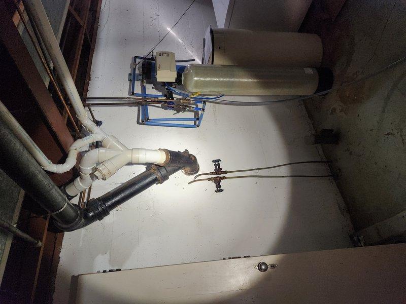 Responded to whole-house drainage issue with main sewer line backup affecting main floor bathroom. Located and accessed main drain cleanout in basement utility area. Deployed professional drain cleaning equipment to clear obstruction in main sewer line, encountering significant blockage consistent with tree root intrusion or pipe damage. Successfully restored drainage flow throughout residence, though recurring nature of issue indicates potential structural compromise requiring camera inspection or line repair in near future.