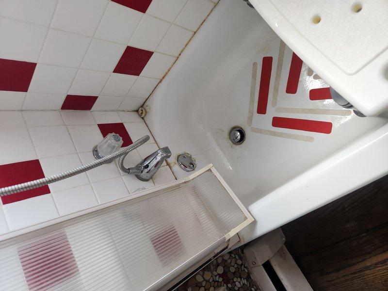 Responded to drainage issues affecting bathroom fixtures, specifically a bathtub and sink experiencing backup conditions. Accessed the main drain cleanout located in the basement area where older cast iron piping connects to newer PVC drainage system. Successfully cleared the main line obstruction, restoring proper drainage flow to all affected fixtures and verifying system operation upon completion.