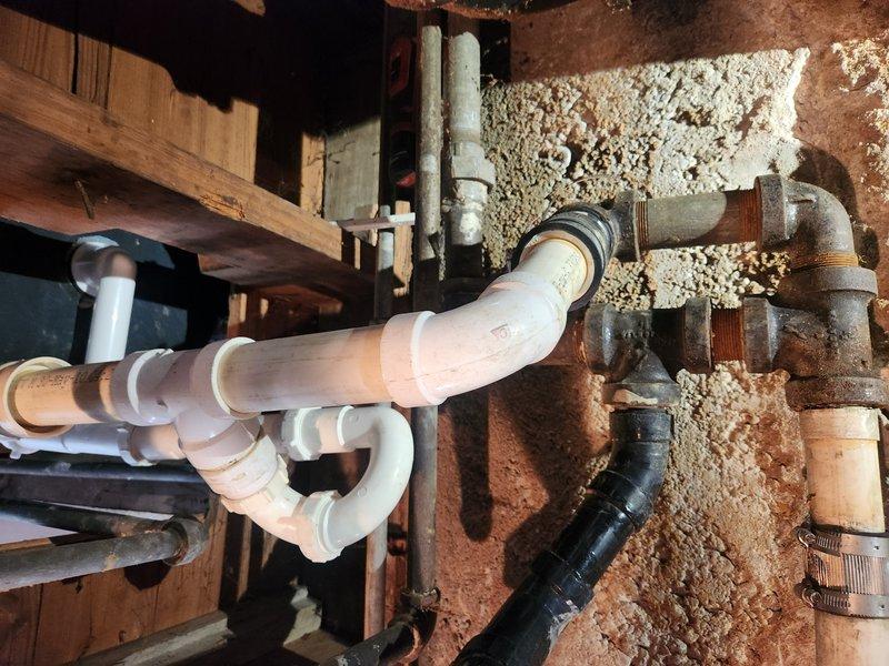 Responded to drainage issues affecting bathroom fixtures, specifically a bathtub and sink experiencing backup conditions. Accessed the main drain cleanout located in the basement area where older cast iron piping connects to newer PVC drainage system. Successfully cleared the main line obstruction, restoring proper drainage flow to all affected fixtures and verifying system operation upon completion.