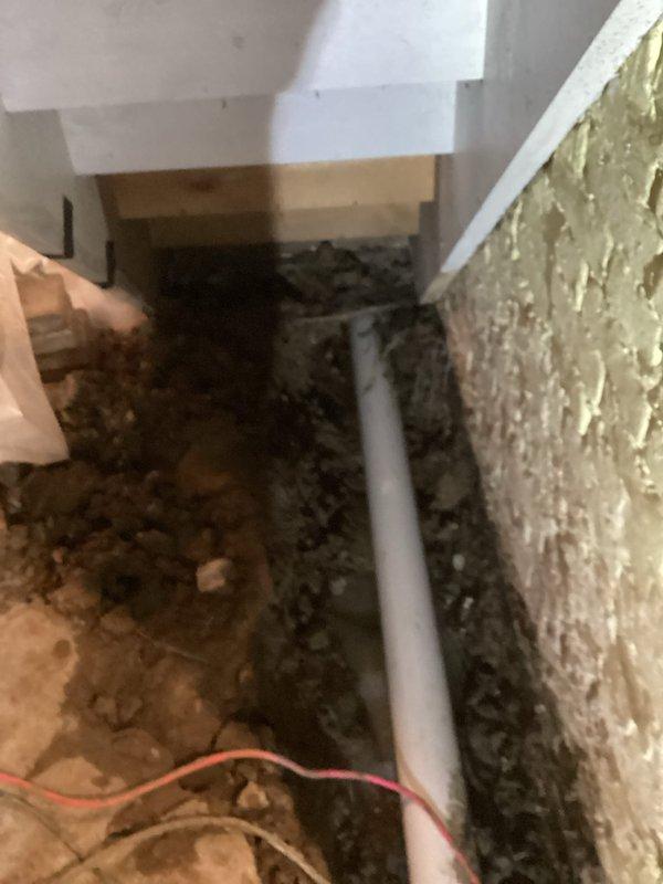 Completed crawl space pipe repair work involving burst pipe remediation. Excavated and prepared trenching in basement area, installed new white PVC drainage piping with proper securing straps and clamps, and finished quoted plumbing repairs. Containment measures were utilized throughout the work area to minimize dust and debris during the installation process.