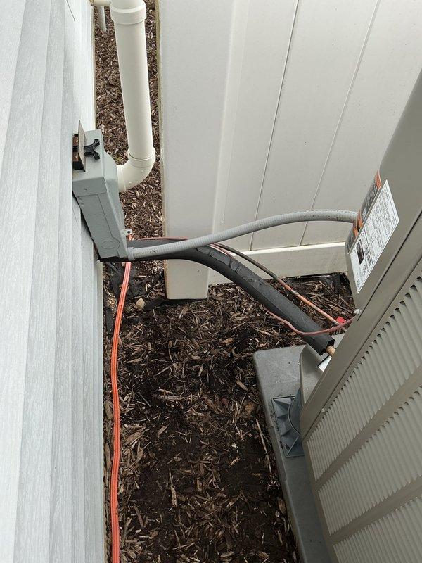 Completed full HVAC system installation including Lennox EL297 high-efficiency furnace, EL16 heat pump, 1610 media filter, and TH6320WF thermostat. Installed heat pump condenser unit on exterior concrete pad with proper clearances from building structure and privacy fence. Ran refrigerant linesets with black foam insulation from outdoor unit to indoor equipment, secured lines with appropriate strapping and routed to electrical disconnect box mounted on exterior wall. Installed PVC condensate drain line vertically along exterior wall for proper drainage. Set condenser unit on mulched landscaped area with adequate service access. Verified all electrical connections at disconnect box and metering equipment. Ran new thermostat wiring as needed to accommodate TH6320WF WiFi-enabled thermostat installation. Completed all refrigerant line connections, evacuated system, and charged to manufacturer specifications. Tested heat pump operation in both heating and cooling modes, verified proper airf