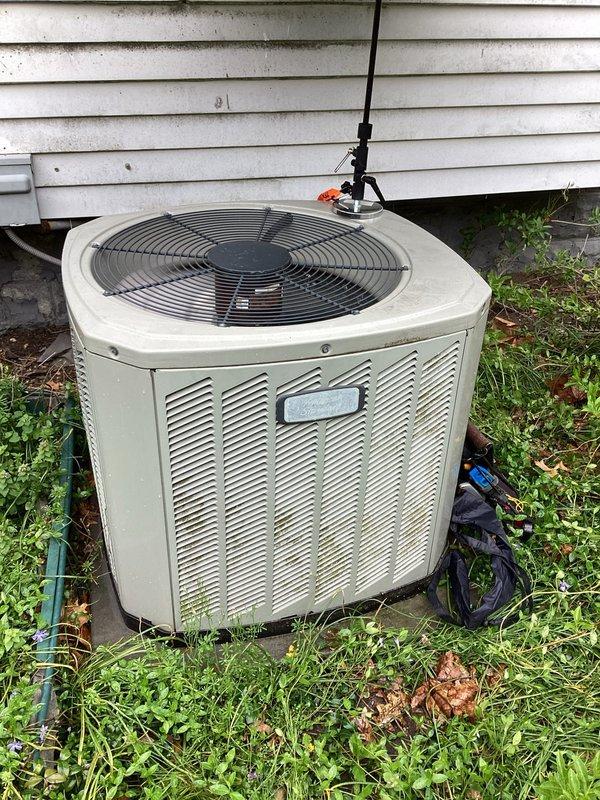 Completed planned maintenance on outdoor air conditioning condensing unit. Performed comprehensive system inspection including examination of electrical components, capacitor, and condenser coil. Unit showed signs of weathering and dirt accumulation but all electrical connections were secure and capacitor tested within acceptable parameters. Documented equipment condition with photographs for maintenance records.