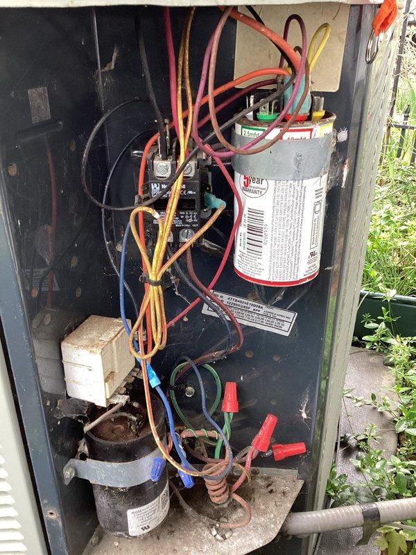Completed planned maintenance on outdoor air conditioning condensing unit. Performed comprehensive system inspection including examination of electrical components, capacitor, and condenser coil. Unit showed signs of weathering and dirt accumulation but all electrical connections were secure and capacitor tested within acceptable parameters. Documented equipment condition with photographs for maintenance records.
