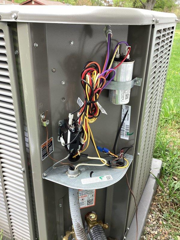 Completed planned HVAC maintenance visit for new enrollment on residential outdoor air conditioning system. Performed comprehensive inspection of condenser unit, including visual assessment of refrigerant lines showing normal oxidation on copper fittings, verified electrical disconnect box condition, documented capacitor installation and wiring configuration, and captured equipment specifications from manufacturer labels for service records.