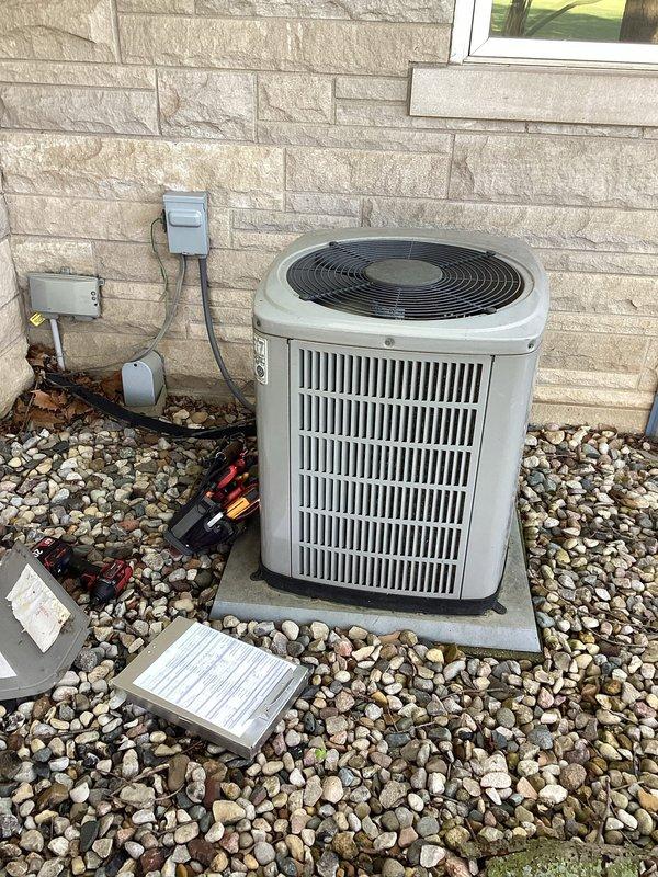 # HVAC Maintenance - Planned Single Maintenance

Performed comprehensive planned maintenance on residential air conditioning system. Conducted thorough inspection of outdoor condenser unit, verifying proper placement on concrete pad and adequate clearance for airflow. Examined exterior components including fan grille, louvers, and cabinet condition.

Accessed electrical compartment and inspected all internal components. Evaluated capacitor condition, verifying proper connections and terminal integrity. Inspected contactor operation and all electrical connections, including wire terminals and splices. Confirmed all wiring color codes and connections meet manufacturer specifications and safety standards.

Documented equipment condition through photographs for maintenance records. System operating within normal parameters. Unit ready for continued service.