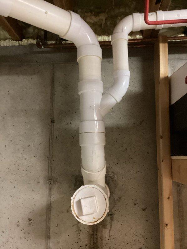 Responded to drainage line leak in lower level of 25-year-old residential property discovered after extended homeowner absence. Upon inspection, located leak in PVC drainage system installed along basement foundation wall. Repaired compromised drainage line section and verified system integrity through pressure testing. Confirmed no additional leaks present elsewhere in the plumbing system throughout the property.