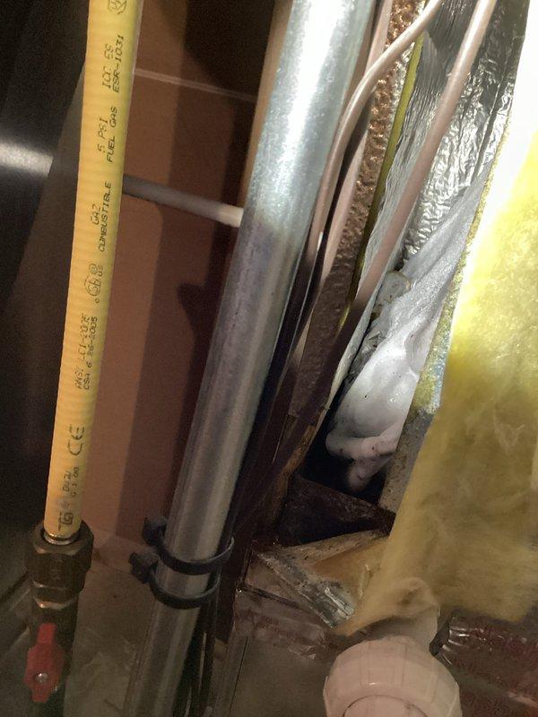 Responded to service call for air conditioning tune-up with reported water pooling issue at furnace. Upon arrival, performed comprehensive system inspection of 4-year-old HVAC unit. Examined furnace cabinet, condensate drainage system, and surrounding mechanical components for source of water accumulation. Inspected PVC condensate drain lines, fittings, and connections for proper pitch and flow. Checked condensate pump operation and discharge piping. Evaluated evaporator coil drain pan for cracks, overflow, or blockage. Assessed humidifier connections and water supply lines for potential leaks. Verified proper installation of all plumbing components and ductwork connections. Examined air handler cabinet for signs of moisture intrusion or condensation issues. Tested system operation to identify any active leaking during runtime. Documented existing conditions with photographs of mechanical room setup, including furnace unit, ductwork, PVC piping, humidifier installation, and surrounding