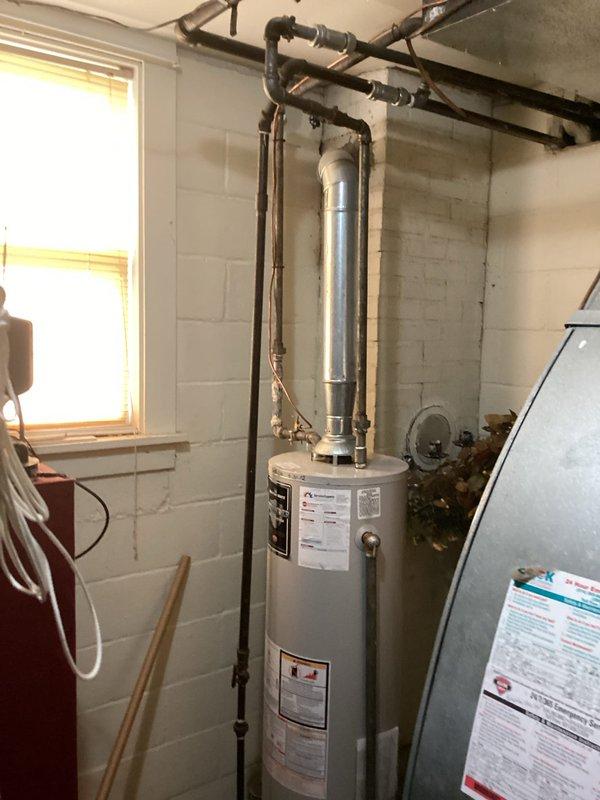 Conducted on-site evaluation of existing water heater installation in residential basement utility area. Assessed current 30-gallon conventional tank water heater with standard venting configuration and documented equipment specifications, piping connections, and available space for potential replacement options. Provided customer with detailed estimates for both traditional tank-style water heaters (30 gallons or less) and tankless water heater alternatives, including discussion of installation requirements, utility connections, and venting modifications needed for each option.