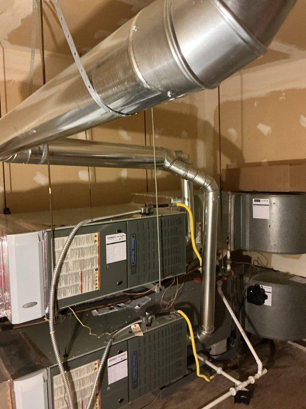 Replaced complete B-vent system for water heater and four furnaces, including new vent piping from appliances through roof penetration. Installed new roof cap and storm collar to ensure proper weather sealing and code compliance. Utilized tow-behind lift from Wakarusa Heavy Equipment to safely access and complete roof-level venting modifications.