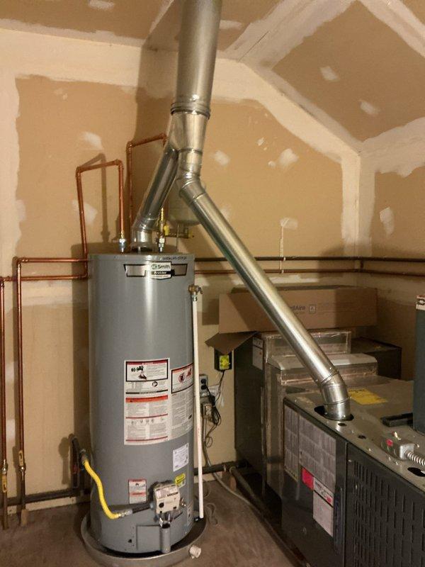 Replaced complete B-vent system for water heater and four furnaces, including new vent piping from appliances through roof penetration. Installed new roof cap and storm collar to ensure proper weather sealing and code compliance. Utilized tow-behind lift from Wakarusa Heavy Equipment to safely access and complete roof-level venting modifications.