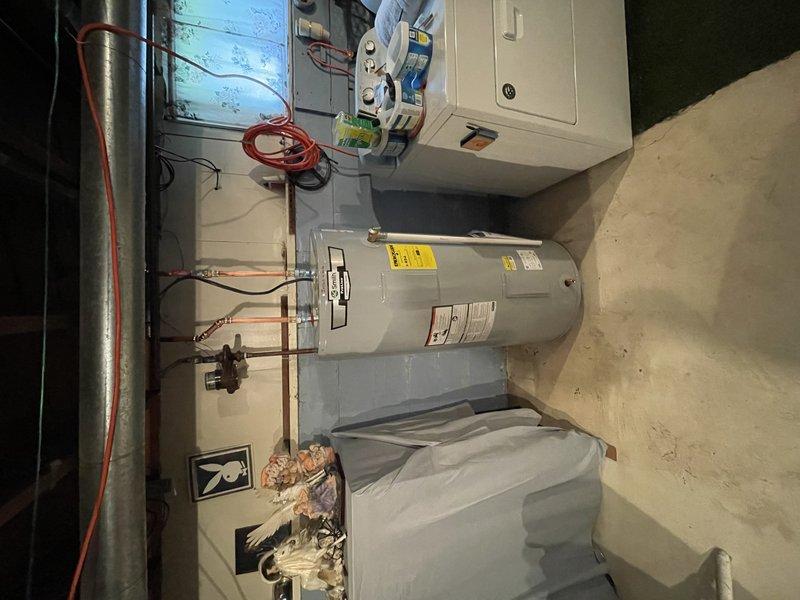 Installed 50-gallon electric water heater in basement utility area with new shut-off valve and associated plumbing connections. Completed all electrical connections to existing circuit panel, verified proper operation of heating elements, and ensured all safety labels and specifications were visible on the unit. Payment collected in full upon completion.