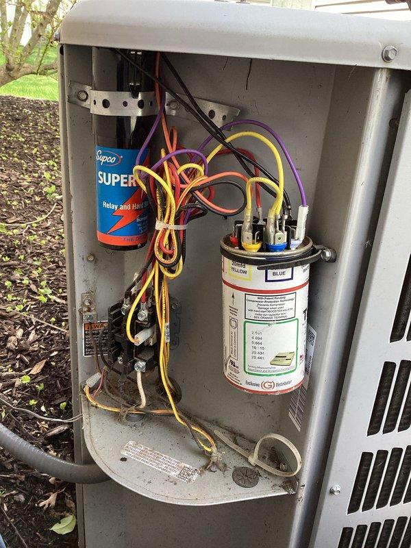 Completed scheduled air conditioning maintenance on outdoor condensing unit. Performed comprehensive system inspection including electrical connections, capacitor testing, and hard start relay evaluation. Removed access panel to inspect internal components, verified proper wiring connections at capacitor terminals, and confirmed operational status of all electrical components. Cleaned and assessed condenser unit exterior, checked refrigerant lines, and ensured proper airflow through coil assembly. Unit operating within normal parameters upon completion of maintenance service.