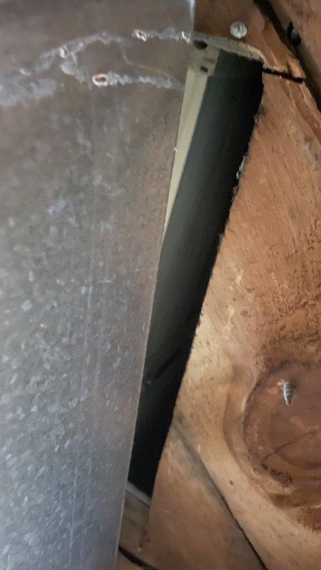 Responded to callback for loose register boot following recent HVAC installation. Upon inspection, found register boot had separated from ductwork connection in attic space. Documented existing conditions with photos showing boot disconnection and surrounding ductwork installation. Unable to definitively determine if issue was directly related to original installation work or resulted from other factors. Secured and reconnected register boot to ensure proper airflow and system operation.