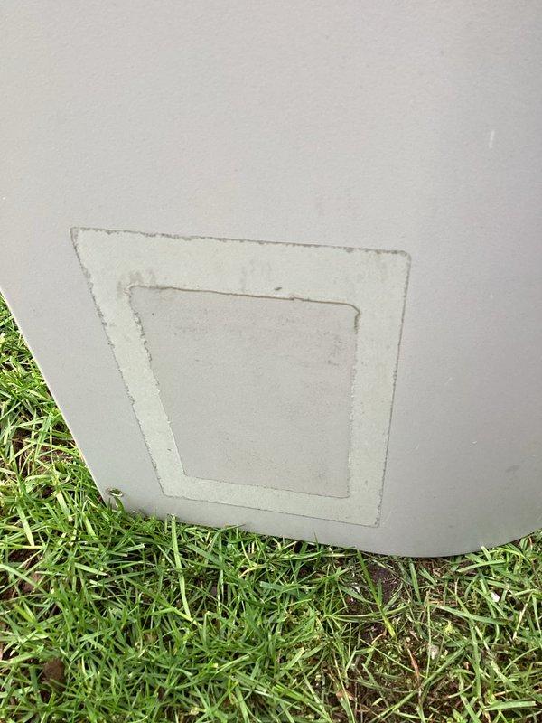 Completed first annual maintenance visit on Gold Level service plan for single HVAC system over 30 years old. Performed comprehensive inspection of outdoor condensing unit, which exhibited significant age-related deterioration including extensive rust and corrosion on protective grille, fan assembly, and central motor housing with visible paint flaking. Documented equipment condition with photographs showing weathered components and oxidation throughout unit surfaces. Inspected interior access panel at ground level and collected filter size information for future service requirements. System confirmed operational for initial seasonal run despite advanced age and exterior weathering of components.