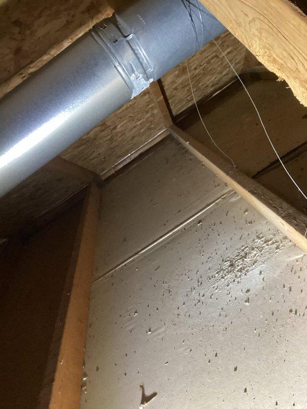Responded to warranty call to assess improperly installed furnace venting system from previous installation approximately five years ago. Upon inspection, discovered that a 3" furnace vent had been incorrectly routed into a 6" common vent with the water heater without proper liner installation, resulting in significant corrosion and moisture leaking. Documented existing conditions with photographs showing corroded ductwork with visible moisture accumulation, substantial debris buildup within the vent system, and deteriorated metal surfaces with oxidation. Evaluated the improper venting configuration and provided assessment of necessary repairs to bring system into compliance with proper venting standards.