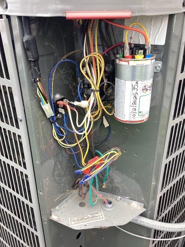 Completed scheduled air conditioning maintenance on residential outdoor condensing unit. Performed comprehensive system inspection including capacitor testing, electrical connections verification, and internal component assessment. All wiring connections were secure with proper color coding observed, capacitor tested within normal operating parameters, and unit operating efficiently with no deficiencies noted.
