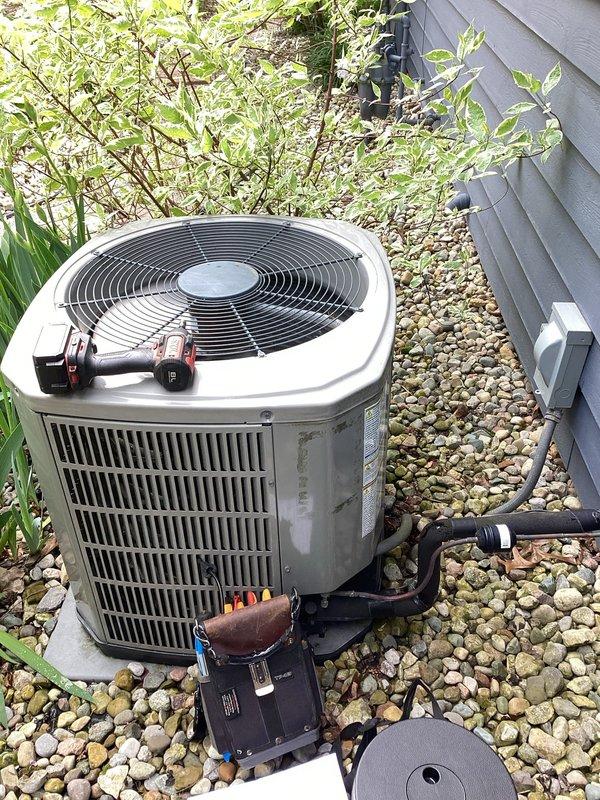 # HVAC Maintenance Service Completed

Performed comprehensive planned maintenance inspection on outdoor condensing unit as part of Gold Level service agreement. Conducted thorough visual inspection of all accessible components with unit access panel removed to evaluate internal electrical and mechanical systems.

Inspected dual capacitor assembly including silver run capacitor and SuperStarter hard start kit for proper operation and signs of deterioration. Verified all electrical connections throughout compartment, including multiple wire runs and terminal connections. Examined contactor relay assembly for contact wear and proper engagement. 

Assessed overall cleanliness of internal cabinet, noting accumulated dust and debris consistent with normal operation. Evaluated wire management and connection integrity of all colored wire runs including power supply and control circuits. Inspected wire connectors for secure attachment and signs of overheating.

Examined exterior condensing coil