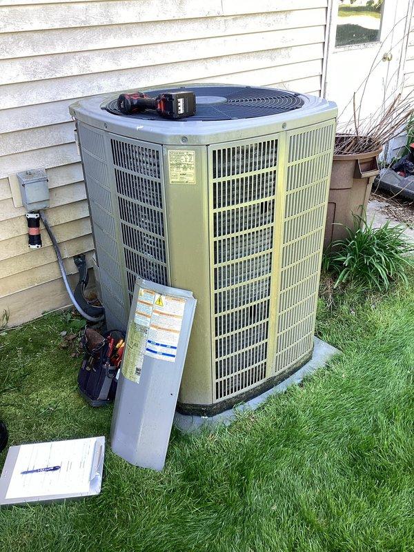 # HVAC Membership - A/C Maintenance Completed

Performed comprehensive planned maintenance on outdoor air conditioning condenser unit. Removed access panel to inspect internal electrical components including capacitor, contactor, and associated wiring connections. All electrical connections were verified secure with proper wire routing observed throughout the compartment. Capacitor tested and found operating within normal parameters. Contactor inspected for proper operation and contact wear.

Conducted visual inspection of condenser coils, noting typical environmental exposure and operational wear on unit surfaces. Exterior cabinet and fan assembly examined for structural integrity. Unit positioned on concrete pad with adequate clearance maintained. All safety covers and access panels reinstalled upon completion of maintenance procedures. System operational and functioning as designed per manufacturer specifications.