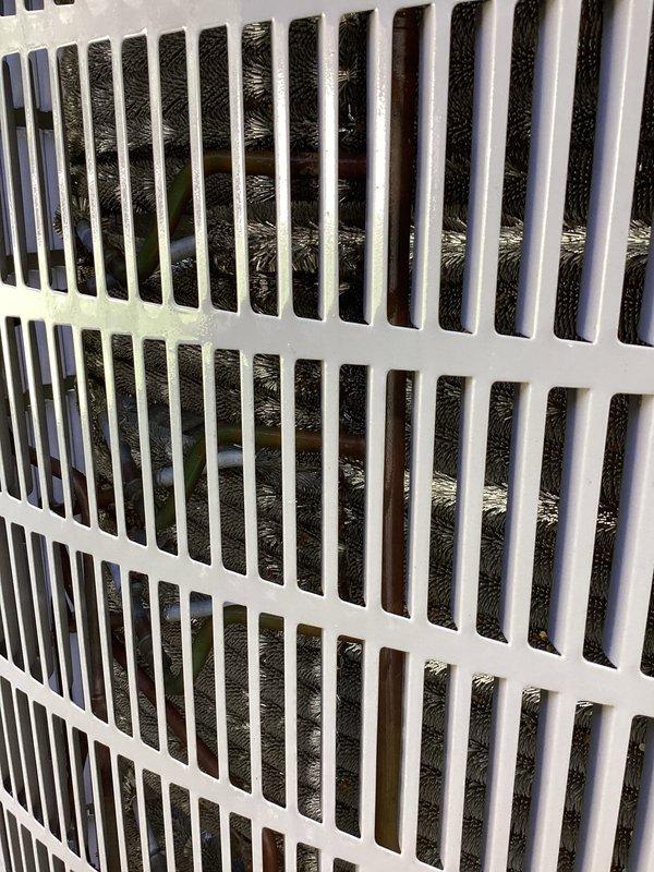 Completed planned air conditioning maintenance per membership agreement. Inspected outdoor condensing unit and identified significant biological growth on condenser coils, particularly in upper sections, which can restrict airflow and reduce system efficiency. Documented condition of indoor air return grille showing accumulated dust and debris on filter media requiring attention. Unit operational at time of inspection.