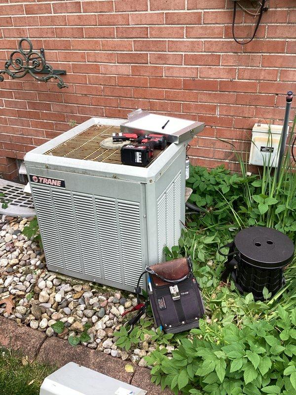 # HVAC Maintenance Service Completed

Performed comprehensive planned maintenance service on Trane brand air conditioning system as part of annual membership maintenance agreement. Conducted thorough inspection of outdoor condensing unit, including visual assessment of cabinet condition, mounting stability, and surrounding clearances. 

Inspected electrical components with unit de-energized, examining the Turbo 2 dual wrap run capacitor for proper connections and physical condition. Verified all wire terminations were secure at capacitor terminals, including purple, yellow, and red wire connections. Checked control accessory components and associated wiring for signs of wear or damage.

Opened top access panel to inspect internal components including copper coil assembly and compressor unit. Evaluated coil condition for debris accumulation, corrosion, or damage. Assessed compressor for proper mounting, unusual wear patterns, and visual signs of operational issues.

Utilized diagnostic 