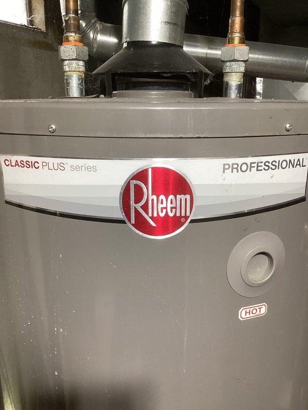 Responded to complaint of hot water producing foul odor with brown, cloudy discoloration upon initial use from well water system. Inspected Rheem Professional Classic Plus Series 75-gallon natural gas water heater (Model PRO+G75-76N RH, manufactured July 2020). Documented unit specifications and current installation condition including copper supply lines, threaded connections, and venting configuration. Identified symptoms consistent with bacterial growth in water heater tank, common in well water applications where anaerobic bacteria react with magnesium anode rod producing hydrogen sulfide gas and sediment accumulation causing discoloration and odor issues.