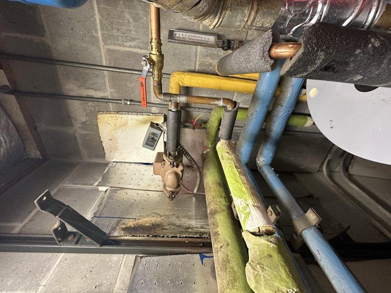 Responded to service call for hot water recirculation pump replacement. Upon arrival, performed comprehensive inspection of domestic hot water system and recirculation components in mechanical room. Evaluated existing pump installation, associated piping connections, and system configuration. Assessed copper piping, brass fittings, and shut-off valves serving the recirculation loop. Inspected condition of surrounding plumbing infrastructure including water heater connections and distribution piping. Documented current system layout and equipment condition through photographic documentation. Provided assessment of recirculation pump requirements and recommended options for replacement to restore proper hot water circulation throughout the residence.
