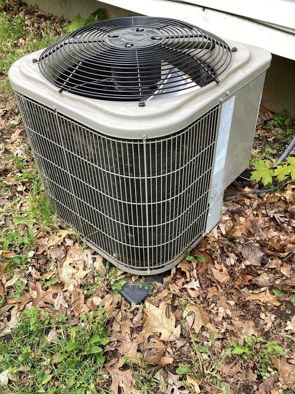 # HVAC Maintenance Completed

Performed planned preventive maintenance on outdoor air conditioning condensing unit. Inspected condenser coil fins and fan assembly through top guard, verified proper airflow around unit perimeter. Accessed service panel to check refrigerant line connections and service ports. Observed accumulation of leaves and debris around unit base that could restrict airflow. All refrigerant hoses and connections inspected for wear and proper installation. Unit operational at time of service visit.