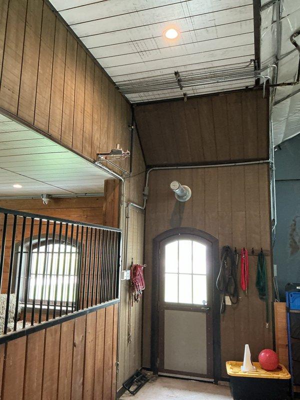 Removed unit heater from above horse stalls in barn structure and capped refrigerant lines. Unit was relocated to driveway for customer retention, and all penetrations were properly sealed to maintain building envelope integrity.