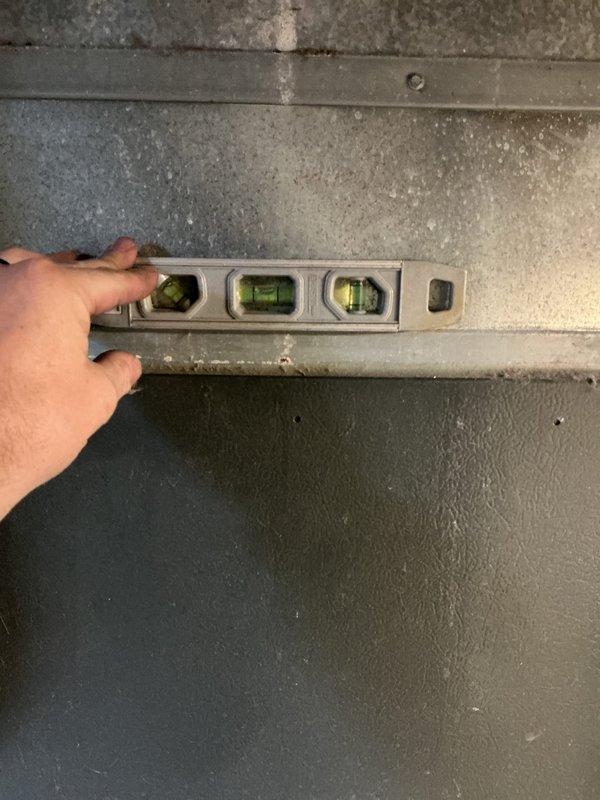 Responded to HVAC install callback to address improper evaporator coil drainage. Upon inspection, confirmed the evaporator coil was back-sloped and not level, preventing proper condensate drainage. Documented the installation deficiency with level measurements and photographs of the affected equipment and surrounding mechanical room setup for corrective action planning.