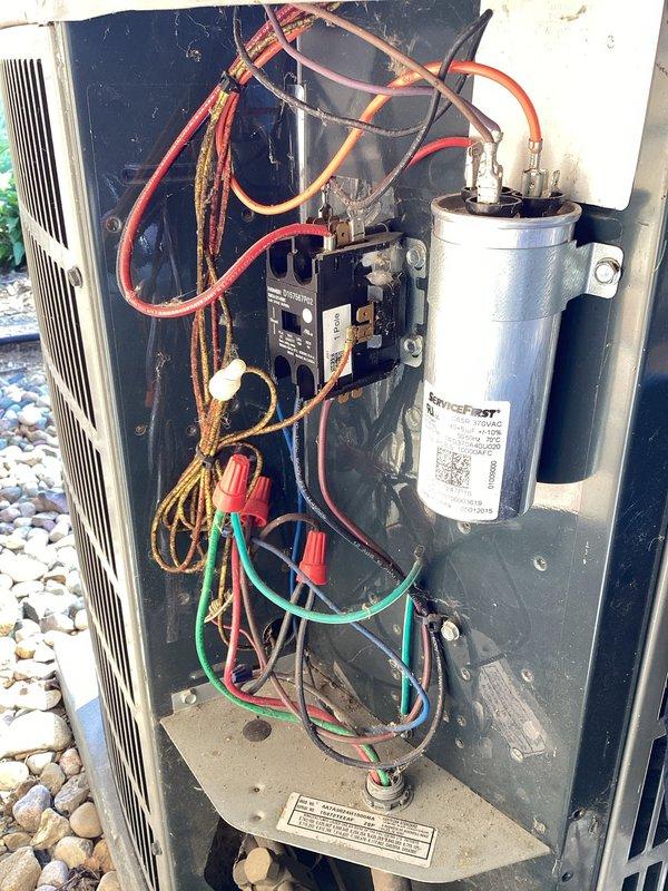 # HVAC Maintenance - Planned Single Maintenance

Completed comprehensive air conditioning maintenance on outdoor condensing unit. Performed full system inspection including electrical compartment evaluation, where dual-run capacitor, contactor, and all wire connections were examined for proper operation and signs of wear. Noted aging electrical connections with visible weathering and discoloration on certain wire terminations. Cleaned condenser coils, verified refrigerant pressures, checked amperage draws on compressor and fan motor, and confirmed proper airflow through louvered panels. Unit operating within normal parameters upon completion of scheduled maintenance visit.