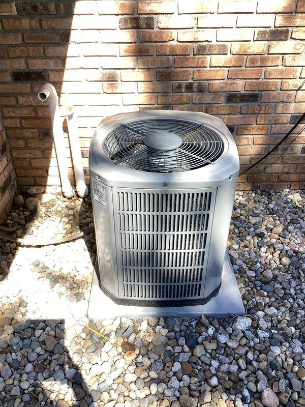 # HVAC Maintenance - Planned Single Maintenance

Completed comprehensive air conditioning maintenance on outdoor condensing unit. Performed full system inspection including electrical compartment evaluation, where dual-run capacitor, contactor, and all wire connections were examined for proper operation and signs of wear. Noted aging electrical connections with visible weathering and discoloration on certain wire terminations. Cleaned condenser coils, verified refrigerant pressures, checked amperage draws on compressor and fan motor, and confirmed proper airflow through louvered panels. Unit operating within normal parameters upon completion of scheduled maintenance visit.