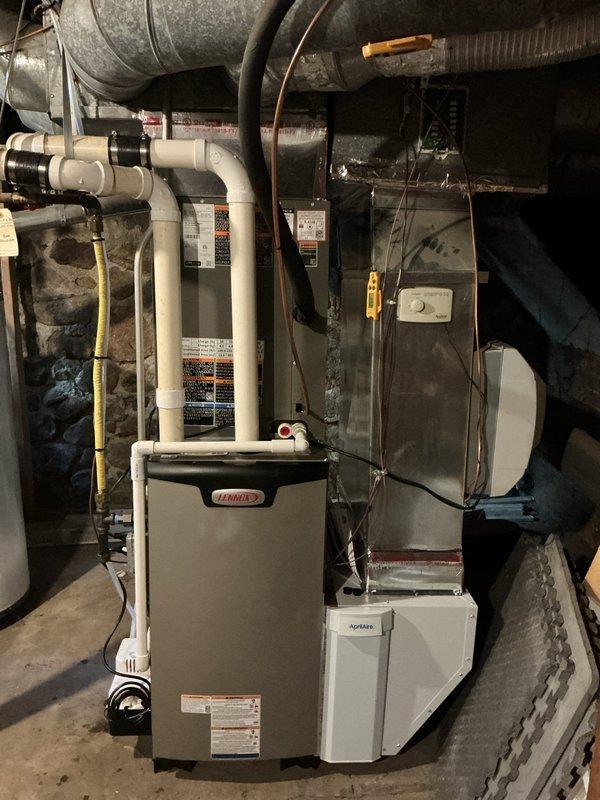 Completed full dual fuel HVAC system installation including Lennox EL297UH070XV36B high-efficiency furnace, EL21KLV-036 heat pump unit, and CK40CT-36B cased evaporator coil. Installed TH6320WF2003 Wi-Fi thermostat programmed for dual fuel operation to optimize heating efficiency between electric and gas sources. Mounted heat pump condenser on 40x40x3 composite pad with proper leveling and clearances. Added 1610 media air cleaner to ductwork for enhanced indoor air quality. Ran and insulated refrigerant lines between indoor and outdoor units, evacuated system, and charged to manufacturer specifications. Installed PVC condensate drain lines and venting per code requirements. Verified all electrical connections, tested system operation in both heating and cooling modes, confirmed proper airflow across coil, and ensured seamless switchover between heat pump and furnace stages based on outdoor temperature thresholds.