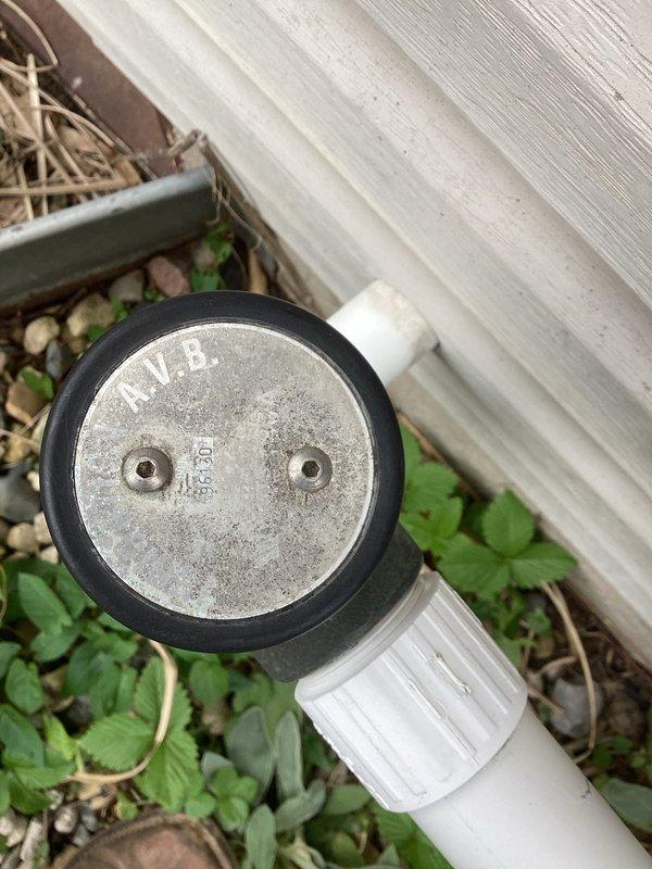Responded to service call for toilet with no water supply. Upon inspection, discovered exterior water supply line feeding the fixture had sustained damage to the PVC piping system. The vertical supply pipe section showed visible breakage and compromise to the pipe integrity. Identified the affected area on the building's exterior wall where the horizontal supply line transitions through a 90-degree elbow connection before the damaged vertical section. The break in the pipe was preventing water from reaching the toilet fixture on the main floor, resulting in the reported no-water condition.