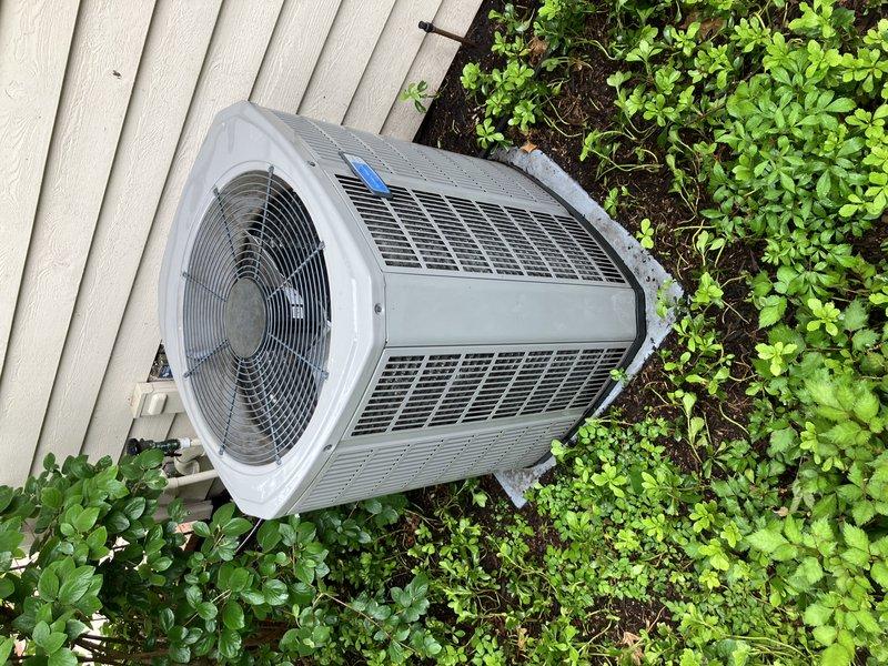 Completed annual air conditioning maintenance on 7-year-old cooling system as part of membership maintenance program. Performed comprehensive inspection of outdoor condensing unit, verified proper operation of condenser fan and protective grille, examined heat exchanger coils and louvers for debris accumulation and airflow restriction. Inspected refrigerant line connections and drainage system including exterior P-trap configuration, confirmed proper condensate discharge through PVC drainage piping. System operating within normal parameters with no immediate service needs identified at time of visit.