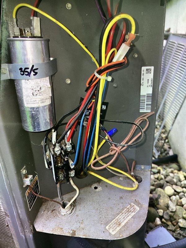 # HVAC Maintenance Completed

Performed planned air conditioning maintenance on outdoor condensing unit as part of recurring membership service. Inspected electrical control panel components including capacitor (marked 35/5 MFD), contactor, and associated wiring connections. Verified proper wire routing and terminal connections throughout control cabinet. Examined condenser coil condition through cabinet louvers and assessed overall unit operation. Documented equipment condition with photographs showing electrical components and exterior unit condition. Unit operational upon completion of maintenance inspection. Note: Filter service not included in this maintenance visit per service agreement terms.