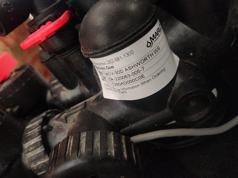 Responded to first-time service call to investigate reported issues allegedly related to improper winterization from previous year. Conducted thorough inspection of plumbing system, focusing on water supply lines, shut-off valves, and associated fixtures in cabinet area. Documented existing conditions with photographs showing HSV30D ASHWORTH1WS system component with visible identification label, as well as under-sink plumbing configuration featuring red wheel-style shut-off valves, braided stainless steel supply lines, and PEX tubing connections. Findings will be discussed with management for review and determination of any corrective action needed.