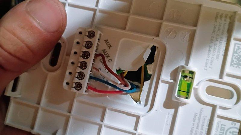 Installed new programmable thermostat with customer-supplied part. Connected multi-stage wiring to terminal block, verified level installation, and programmed unit for cooling operation. System tested and operational, currently maintaining setpoint of 65°F.