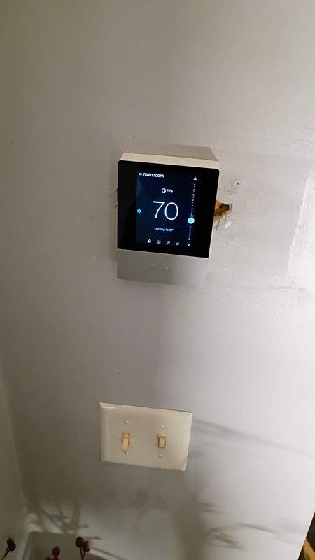 Installed new programmable thermostat with customer-supplied part. Connected multi-stage wiring to terminal block, verified level installation, and programmed unit for cooling operation. System tested and operational, currently maintaining setpoint of 65°F.