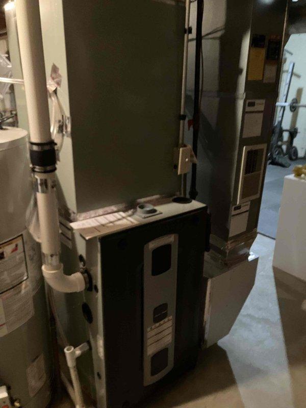 Conducted on-site evaluation of existing HVAC system in basement mechanical room for complete air conditioning replacement. Assessed current equipment configuration including furnace, air handler, and outdoor condensing unit compatibility. Documented equipment dimensions and clearances, measuring 36" height, 31" and 21" width specifications for replacement unit planning. Customer specifically requested quote for ML17KC2 non-communicating system with alternative options provided. Photographed existing installation layout including ductwork connections, PVC condensate drainage, electrical service panel, and available workspace. Evaluated mechanical room access, ceiling height clearances, and existing infrastructure to ensure proper sizing and installation feasibility for proposed replacement equipment.