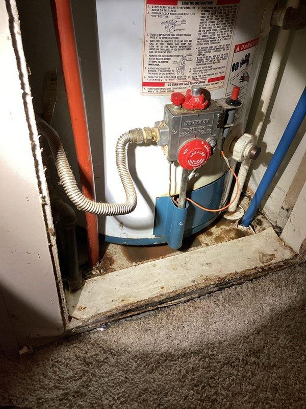 Responded to service call for 40-gallon gas water heater in mobile home that would not ignite. Performed on-site inspection of tanked water heater installation, examining gas control valve assembly, pilot light system, and gas supply connections. Documented existing installation conditions including flexible gas connector, control valve with red knobs, and venting configuration. Assessed unit for potential repair versus replacement options and photographed equipment including gas valve assembly, plumbing connections, and warning labels in utility closet compartment. Provided technical evaluation and recommendations to customer regarding water heater serviceability.