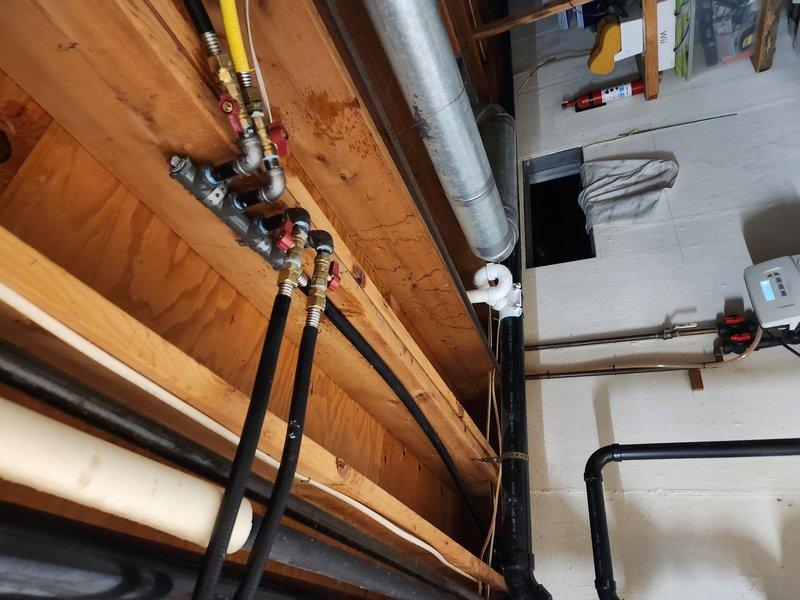 Completed re-run of gas lines using 3/4" Omegaflex flexible gas piping throughout basement and exterior utility areas. Installed new gas distribution lines with proper fittings, securing flexible connectors to structural joists and beams with appropriate mounting hardware. Routed piping alongside existing plumbing and HVAC ductwork, ensuring proper clearances and code-compliant installation. Added red-handled shut-off valves at key connection points for system isolation and safety. Verified all connections for proper sealing and tested system integrity upon completion.