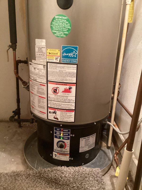 Responded to service call for intermittent hot water issues on approximately 10-year-old residential water heating system. Upon arrival, performed diagnostic inspection of American Standard Polaris heating unit and associated plumbing components. Evaluated copper piping network, pressure gauges, shut-off valves, and control panel indicators. Inspected unit for potential leaks, verified drain pan condition, and examined all visible connections and fittings. Documented system configuration including Energy Star certified unit with multiple safety labels and warning indicators. Assessed control panel operation, temperature settings, and indicator lights to determine intermittent performance patterns reported by occupant regarding insufficient hot water supply and duration.