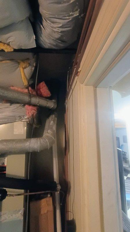 Responded to no cooling call on one-year-old residential air conditioning system. Upon arrival, confirmed unit was not powering on with no airflow at registers and no breaker trips reported. Performed diagnostic evaluation of HVAC system located in basement utility area. Inspected electrical connections, thermostat communication, and condensing unit operation. Assessed ductwork installation and insulation integrity throughout mechanical space. Documented system conditions with photographs showing basement HVAC infrastructure including insulated supply ducts, mechanical routing, and overall installation quality. Provided homeowner with findings and recommendations for restoring cooling operation to the system.