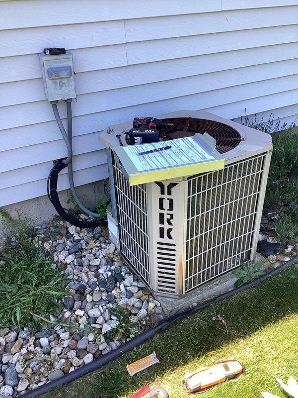 # HVAC Maintenance - Planned Single Maintenance

Completed comprehensive preventive maintenance service on York brand residential air conditioning system per membership agreement. Performed thorough inspection of outdoor condensing unit including electrical connections, capacitor, compressor components, and all associated wiring. Cleaned condenser coils, removed accumulated debris including leaves and organic matter from unit base and internal components, and verified proper airflow through protective grilles. Inspected electrical disconnect box and conduit for proper operation and secure connections. Confirmed unit is operating within normal parameters and ready for continued service during cooling season.