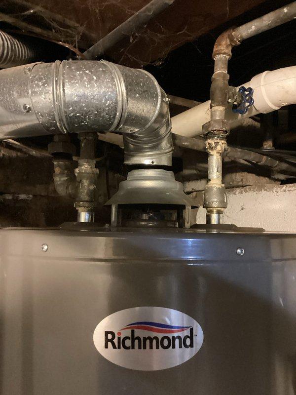 Responded to service call for non-operational water heater. Conducted comprehensive inspection of Richmond brand natural gas water heater, model GCN-38, manufactured May 2023. Assessed unit condition, examined plumbing connections, flue pipe assembly, and shutoff valves. Documented equipment specifications including serial number, gas type, and pressure ratings. Photographed installation for diagnostic evaluation and potential replacement quote preparation.