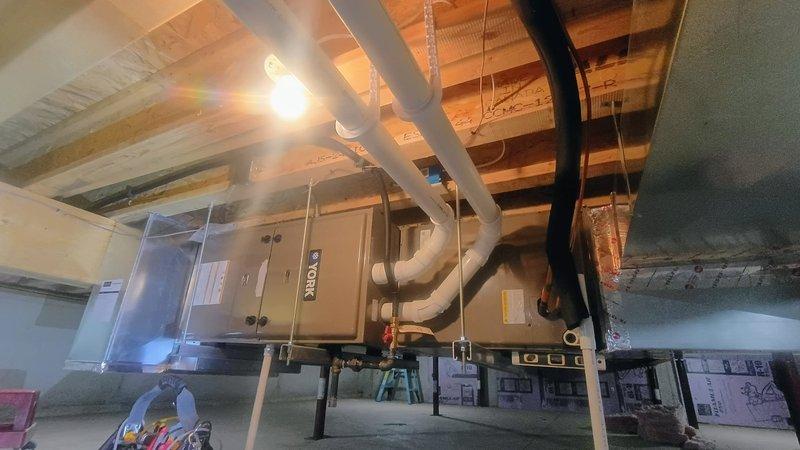 Completed planned HVAC membership maintenance including air conditioning system inspection and filter replacement in basement-mounted unit with accessible ductwork distribution system. Performed comprehensive plumbing inspection of utility area, verifying proper appliance installation and levelness using precision measurement tools to ensure optimal equipment operation and system efficiency.