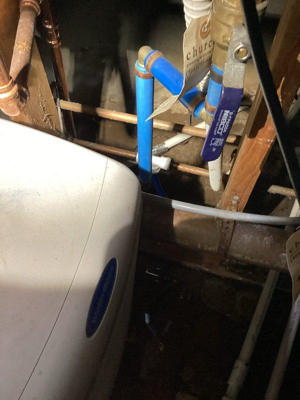Responded to service call for standing water in crawlspace with suspected HVAC or plumbing leak. Upon inspection, examined furnace area adjacent to crawlspace and surrounding utility equipment including water softener system and associated plumbing connections. Photographed installation to document current conditions of blue PEX piping, copper lines, and drainage components in utility area. Determined leak source was not related to HVAC system, as 4-year-old furnace showed no signs of condensate line failure or refrigerant leakage.
