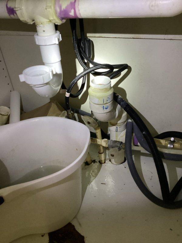 Responded to kitchen sink clog with water leaking onto floor. Customer had previously attempted to clear drain with foam cleaner four days prior without success. Upon inspection, accessed cabinet beneath sink and identified blockage in drain line. Utilized mechanical drain clearing equipment to remove obstruction from P-trap and drain assembly. Cleared accumulated debris causing backup and leak. Tested drainage flow and verified proper function of all connections. Cleaned work area and confirmed no additional leaks present. Kitchen sink now draining properly with no water escaping onto cabinet floor.