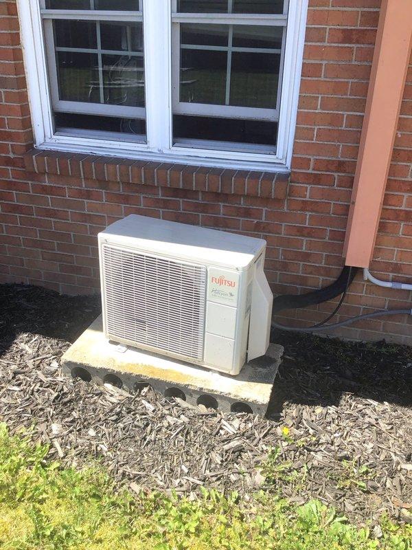 Provided estimate for ductless mini-split system installation in nurses lounge area. Assessed existing space with wall-mounted indoor unit requirements and evaluated exterior location for outdoor condenser placement on concrete pad with refrigerant line set routing through brick exterior wall.